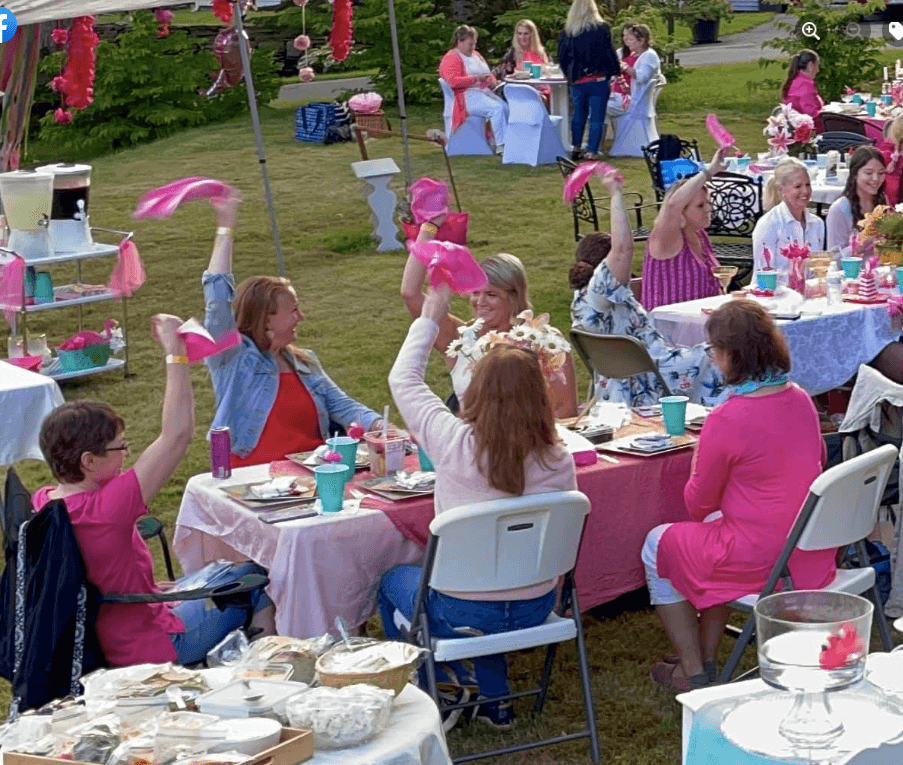 Delta Omega Delta Flamingle party, waving pink napkins.