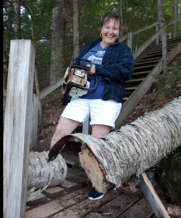 Delta member cutting down tree.